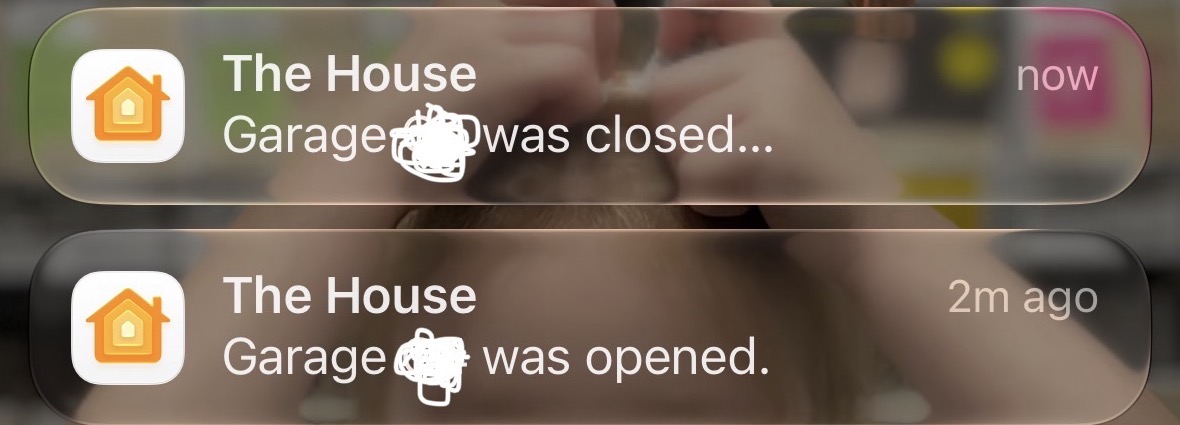 Two Apple Home notifications stacked on an iPhone lock screen. The top one reads "Garage was closed" and is timestamped now; the one below reads "Garage was opened" from two minutes earlier. The door's name is scribbled out in both.